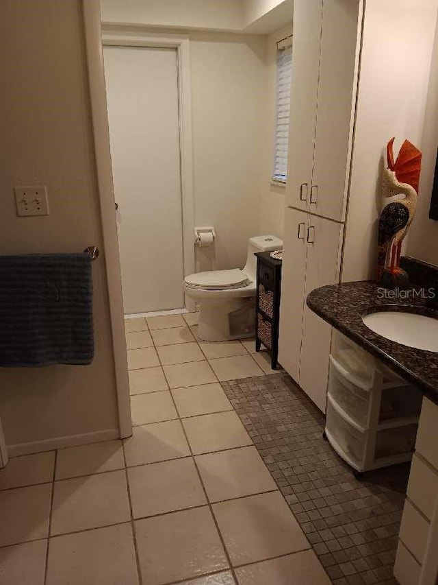 bathroom featuring vanity, toilet, and tile patterned floors