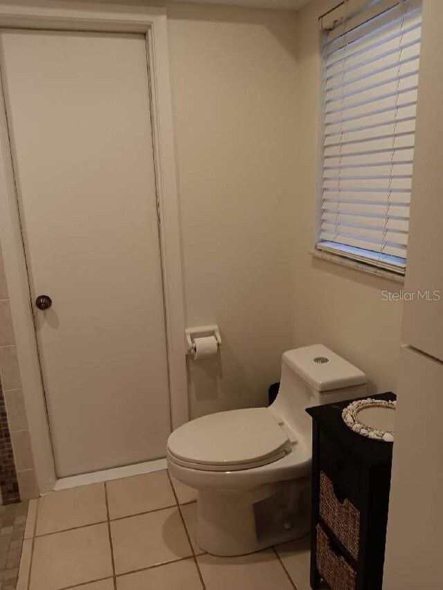 bathroom with vanity, toilet, and tile patterned flooring