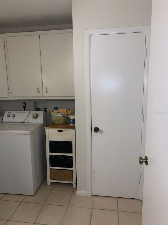 washroom featuring cabinets, washer / dryer, and light tile patterned flooring