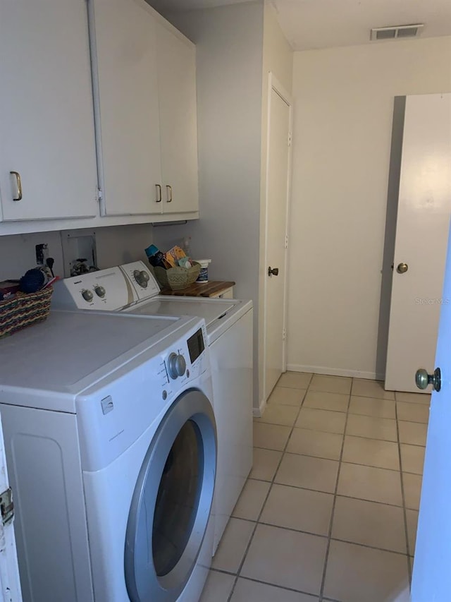 1608 Bob O Link Dr, Venice, FL 34293 - laundry room featuring visible vents, baseboards, washing machine and dryer, light tile patterned floors, and cabinet space