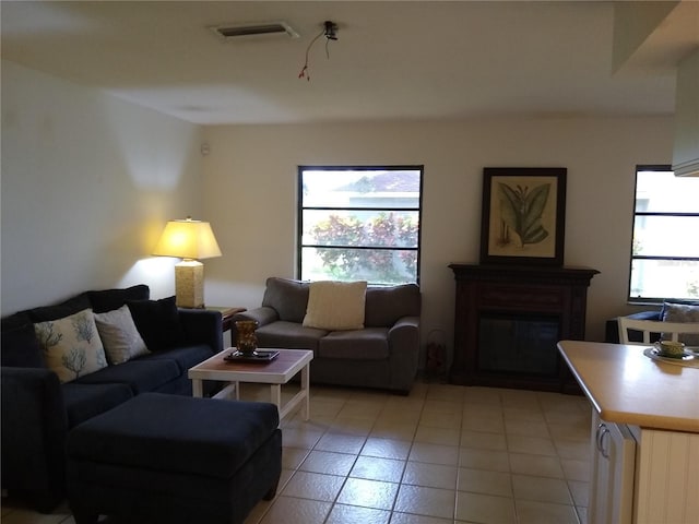 1608 Bob O Link Dr, Venice, FL 34293 - living room with light tile patterned floors, visible vents, and a fireplace