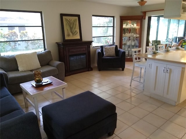 living room featuring a wealth of natural light and light tile patterned floors