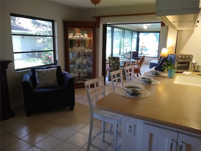 dining room featuring plenty of natural light, ceiling fan, and light tile patterned flooring