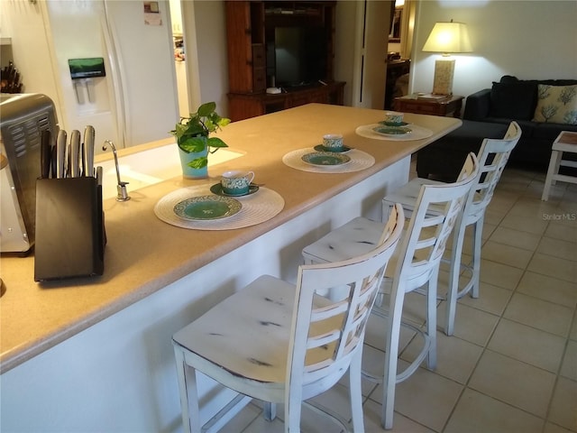 dining area featuring tile patterned flooring