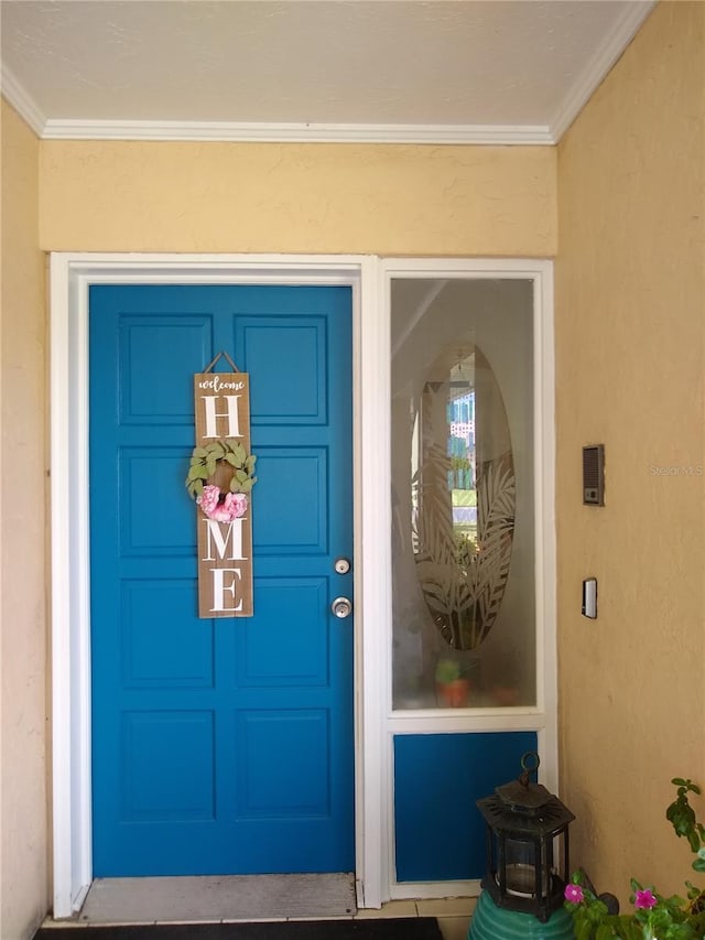 property entrance featuring stucco siding and a garage