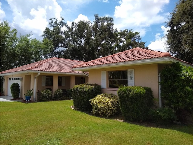 1608 Bob O Link Dr, Venice, FL 34293 - mediterranean / spanish-style house featuring stucco siding, a front lawn, an attached garage, and a tile roof