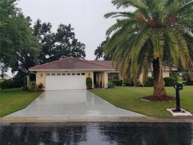 view of front of property with a front yard and a garage