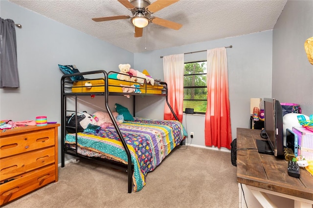 bedroom with ceiling fan, light colored carpet, and a textured ceiling