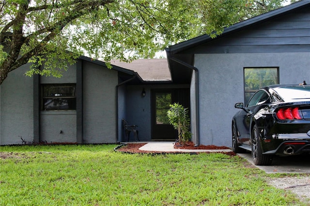 view of front of home with a front lawn and stucco siding