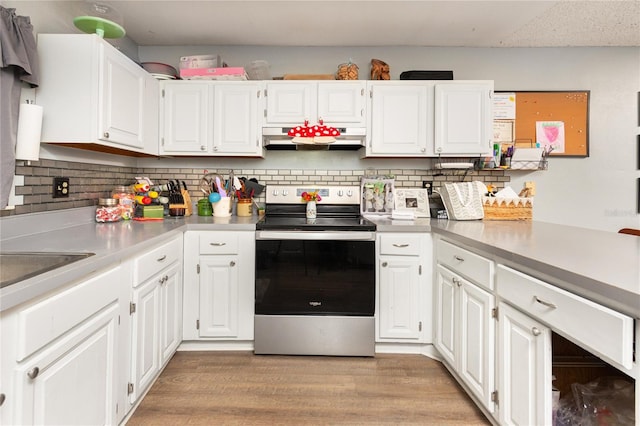 kitchen with range hood, light wood-style floors, white cabinetry, and stainless steel electric stove