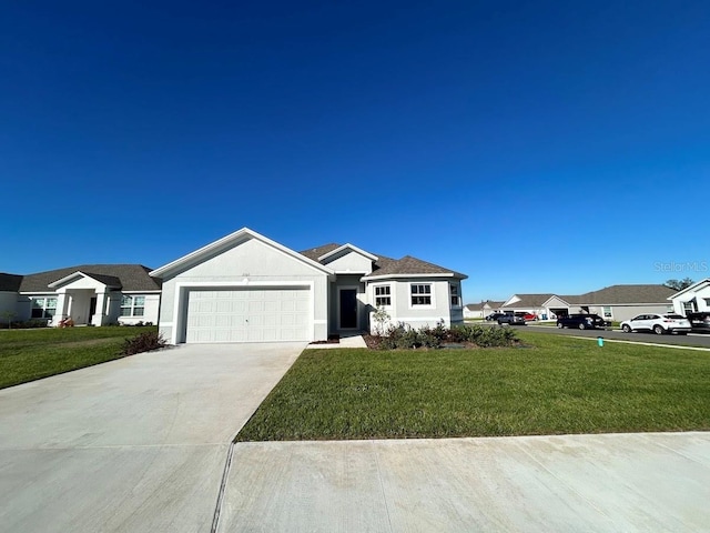 single story home with a garage and a front lawn