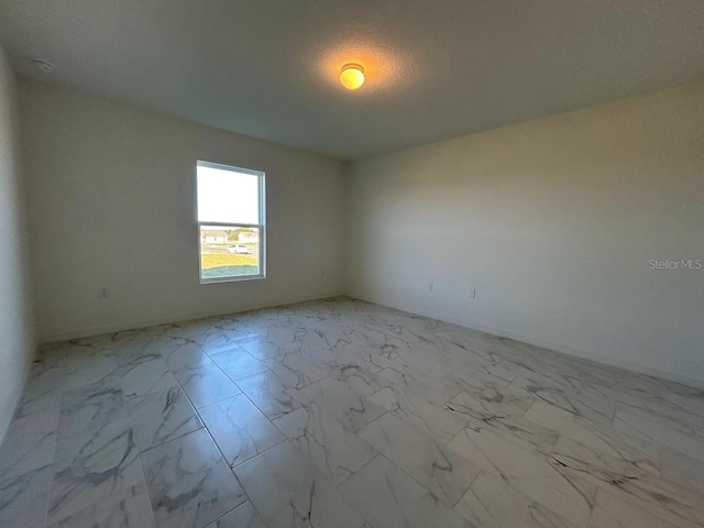 empty room featuring a textured ceiling