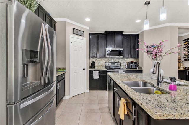 kitchen with decorative light fixtures, sink, crown molding, and stainless steel appliances