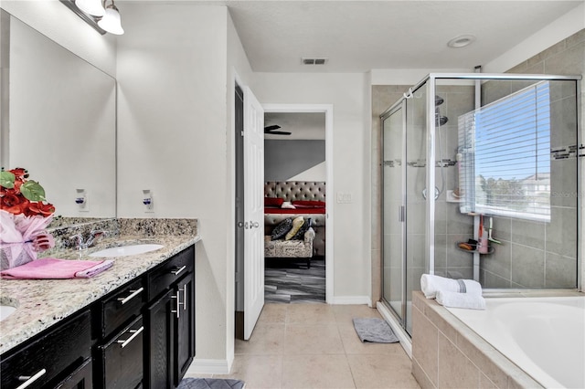 bathroom featuring vanity, tile patterned flooring, and separate shower and tub