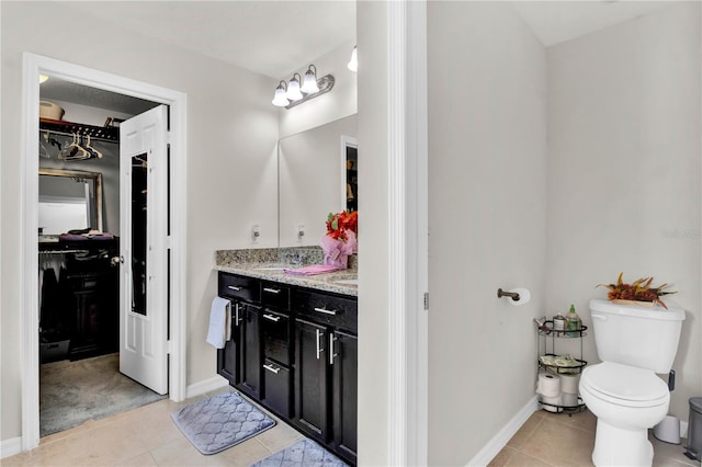 bathroom featuring vanity, tile patterned floors, and toilet