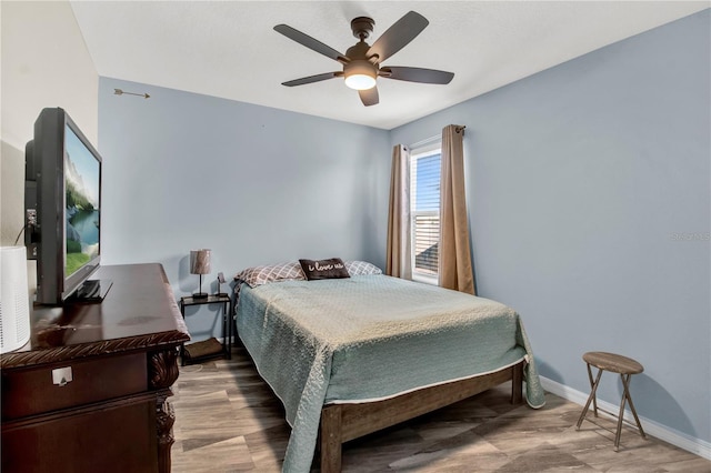 bedroom with hardwood / wood-style flooring and ceiling fan