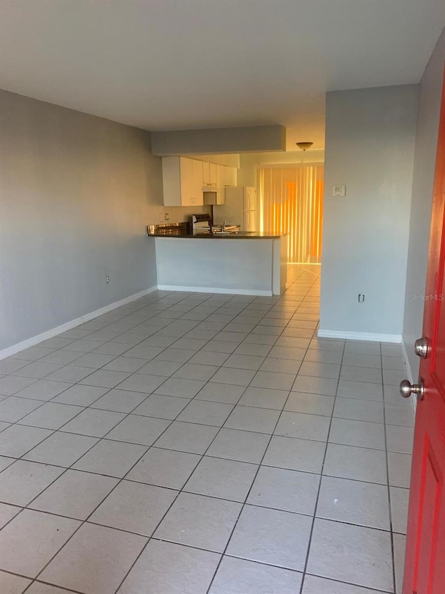 unfurnished living room featuring light tile patterned floors