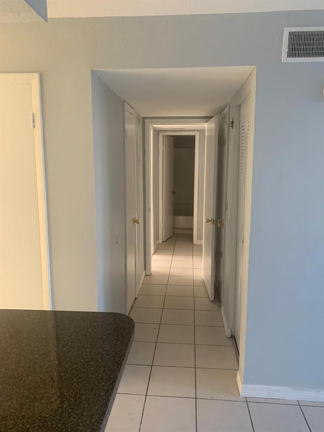 hallway with light tile patterned floors