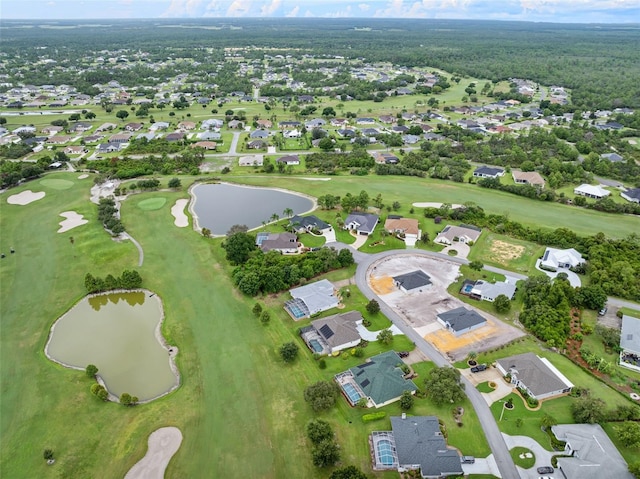 birds eye view of property featuring view of golf course, a water view, and a residential view