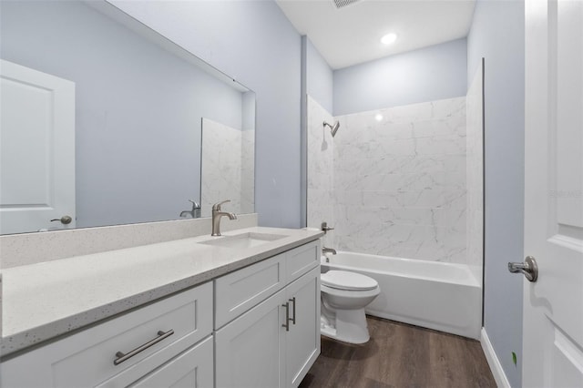 full bath featuring visible vents, toilet, tub / shower combination, vanity, and wood finished floors