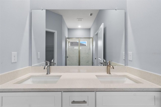 bathroom with double sink vanity and walk in shower