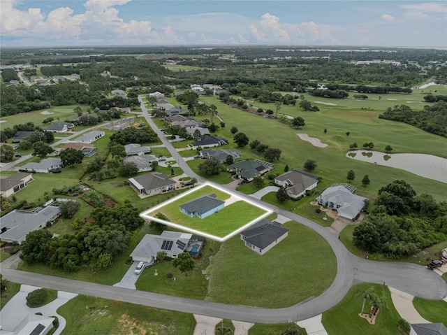 drone / aerial view with view of golf course and a residential view