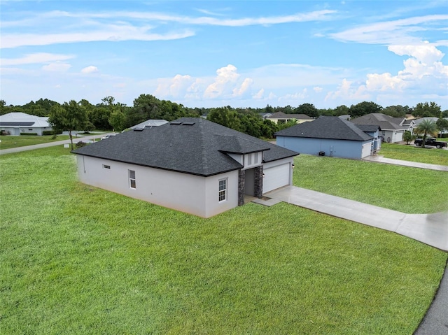 exterior space featuring concrete driveway, roof with shingles, an attached garage, a front lawn, and stucco siding