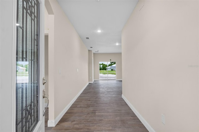 hallway with dark hardwood / wood-style floors