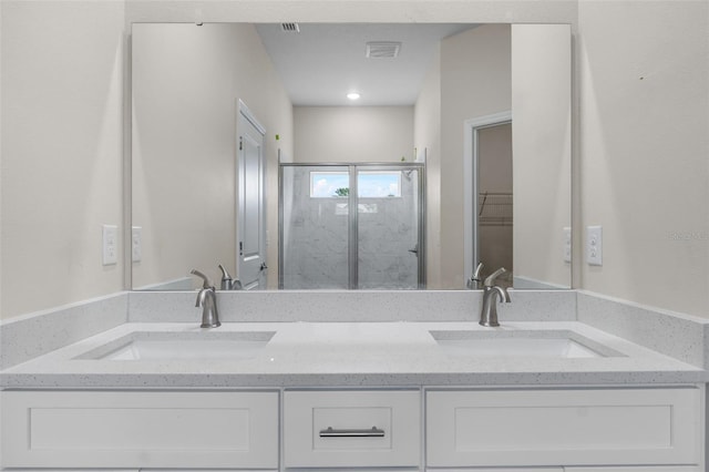 bathroom featuring an enclosed shower and vanity