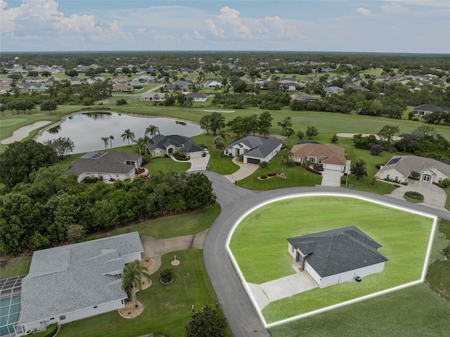 drone / aerial view featuring a water view, view of golf course, and a residential view