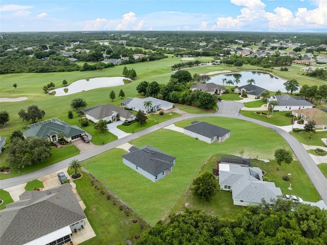 birds eye view of property with view of golf course, a water view, and a residential view