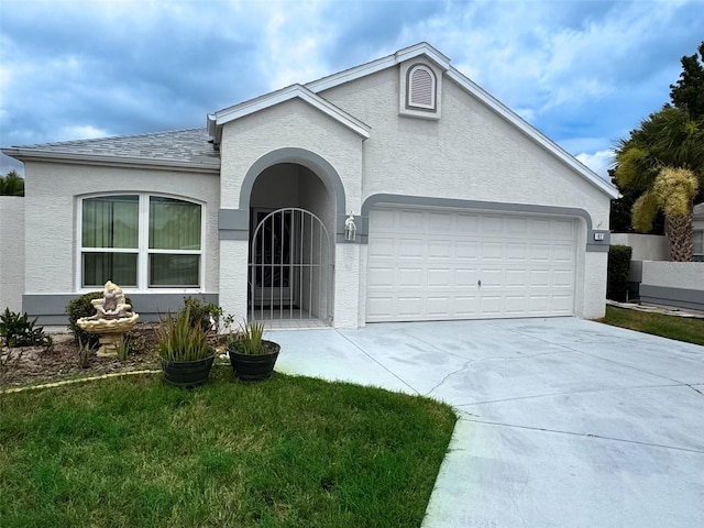 ranch-style house featuring a front yard and a garage