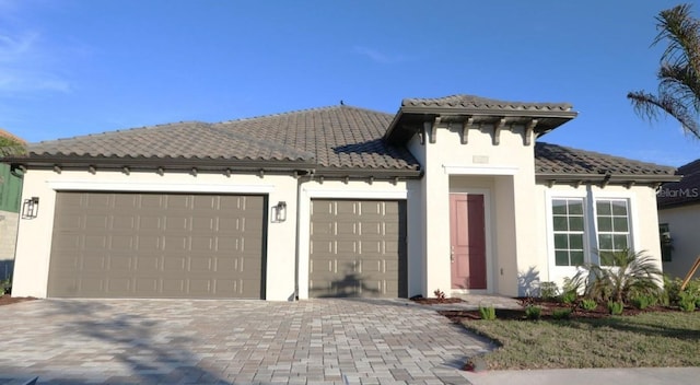 mediterranean / spanish-style house with a garage