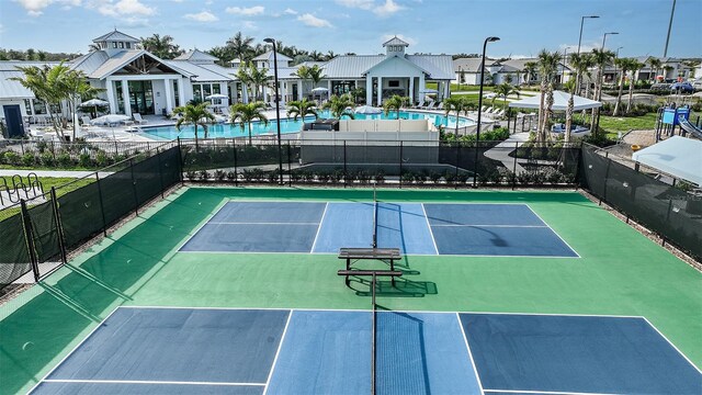 view of sport court with a community pool