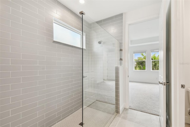 bathroom with plenty of natural light, walk in shower, and tile patterned floors