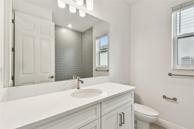 full bath featuring toilet, recessed lighting, baseboards, and vanity