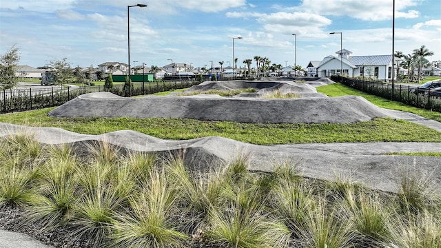 view of property's community featuring fence and a residential view