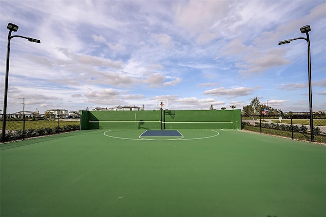 view of basketball court featuring community basketball court and fence