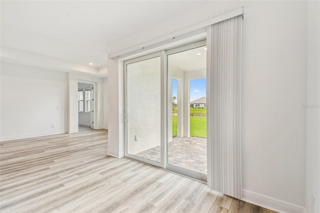 empty room featuring light wood-style flooring, baseboards, and recessed lighting