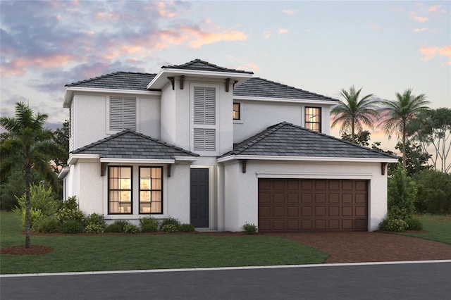 view of front facade featuring a garage and a yard