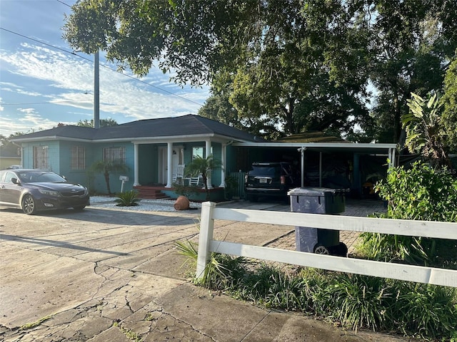 view of front facade with a carport and covered porch