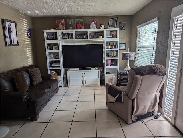 tiled living room featuring a textured ceiling