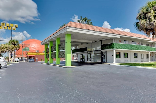 view of building exterior featuring uncovered parking