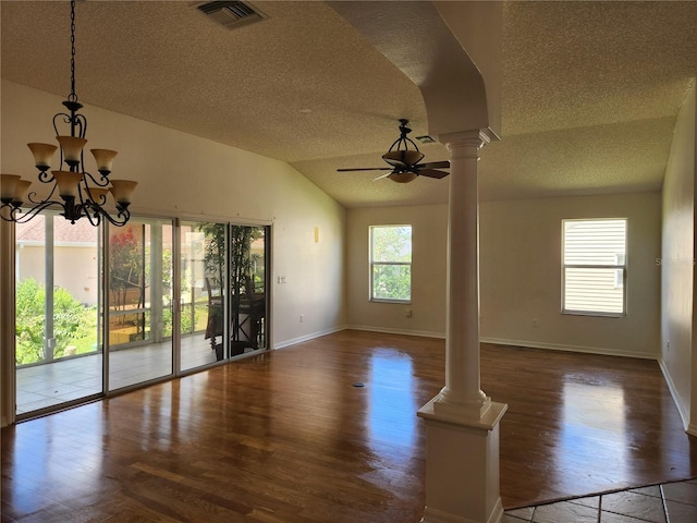 interior space with decorative columns, plenty of natural light, dark wood-type flooring, and vaulted ceiling