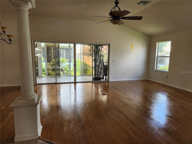 unfurnished living room with hardwood / wood-style floors, lofted ceiling, ceiling fan, ornate columns, and a textured ceiling