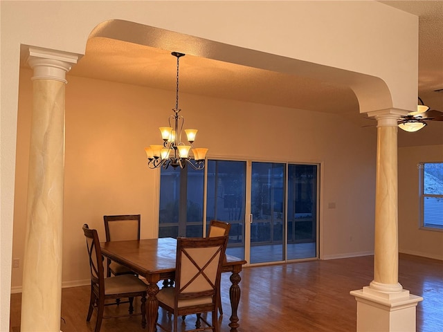 dining room featuring a textured ceiling, ceiling fan with notable chandelier, and dark wood-type flooring