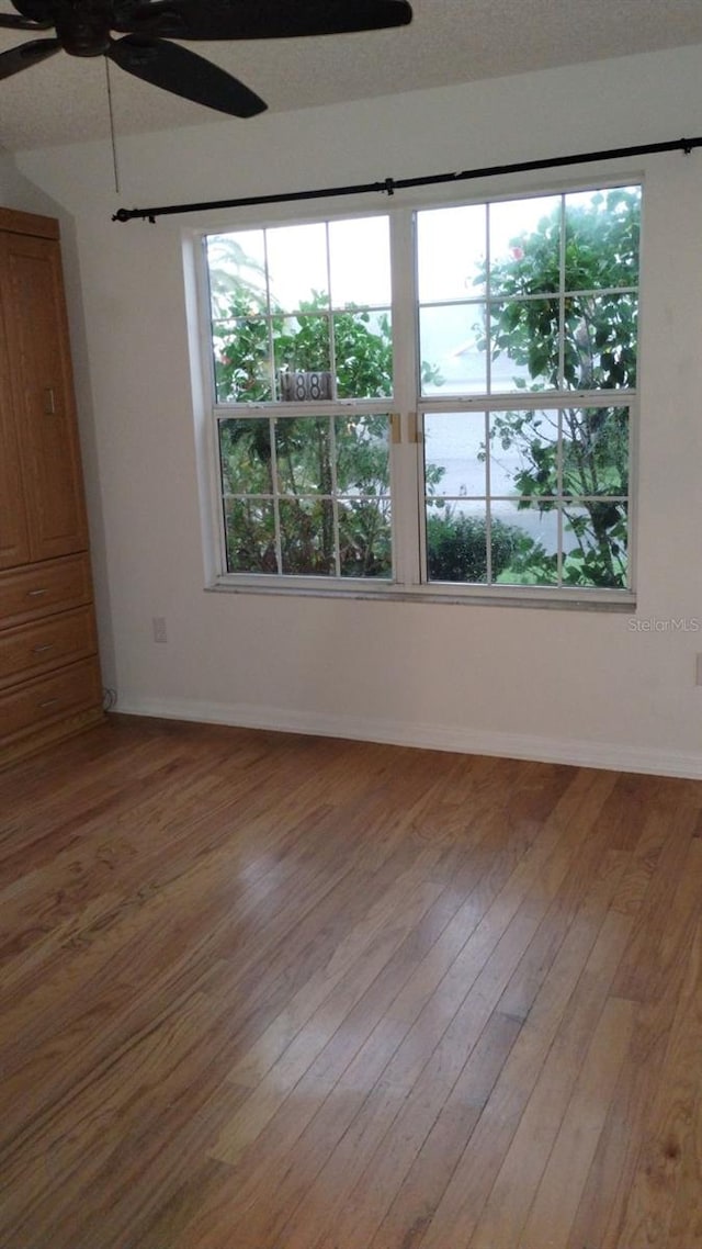 spare room featuring wood-type flooring and a textured ceiling