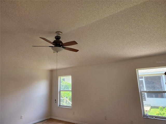 unfurnished room with hardwood / wood-style floors, a textured ceiling, and ceiling fan