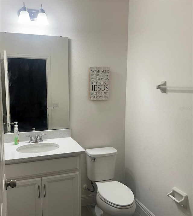 bathroom featuring vanity and toilet