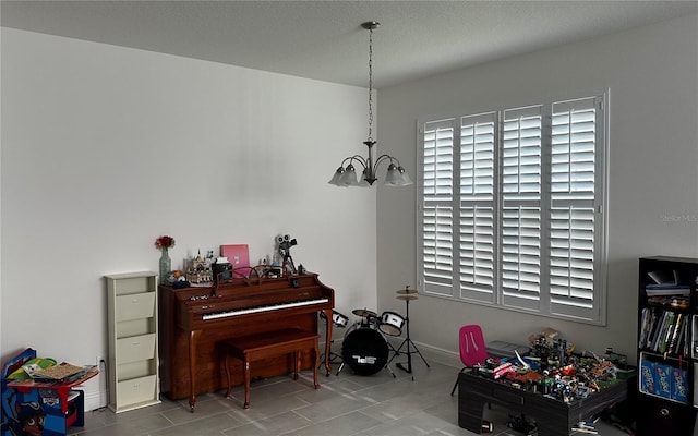 miscellaneous room featuring an inviting chandelier